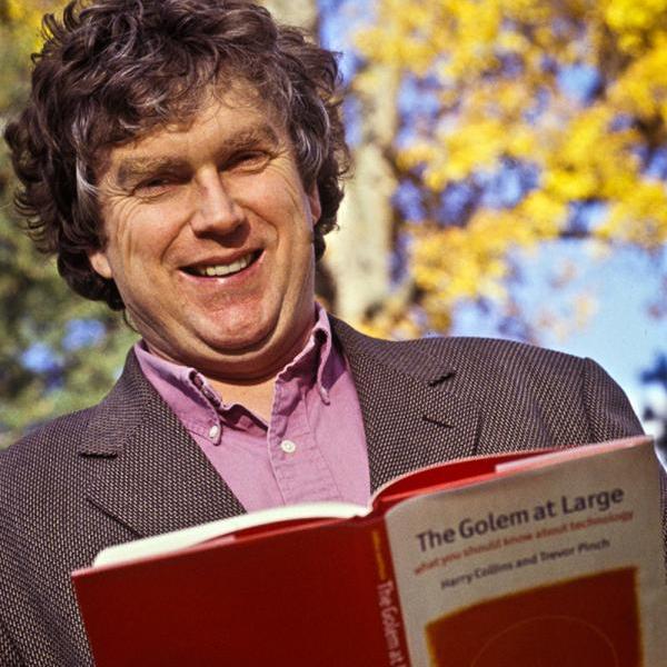 Trevor Pinch smiling and holding his book "The Golem at Large"