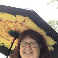 person with sunflower umbrella