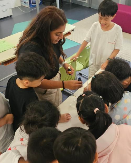 students working with a teacher