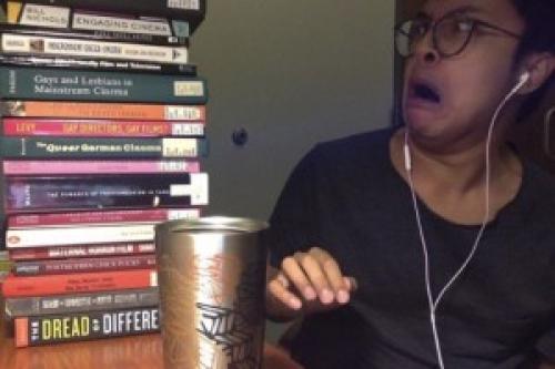  Here&#039;s me, a book pile from phase 1 of my thesis research, and my fifth cup of coffee that night.