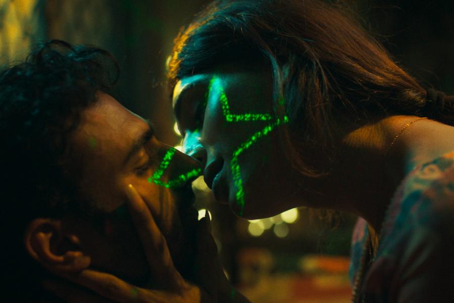 Film still: two people lean in for a kiss with a green star superimposed over their faces